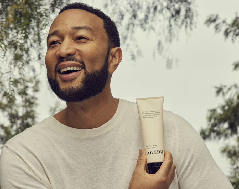 John Legend holding a LOVED 01 product